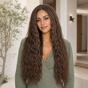 Woman wearing the Hugyoo Warm Brown Wet & Wavy glueless human hair wig in a lifestyle setting.