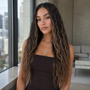 Woman wearing the Hugyoo Bronde Balayage Wet & Wavy glueless human hair wig in a lifestyle setting.