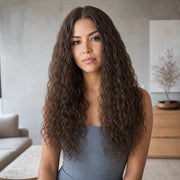 Woman wearing the Hugyoo Cool Brown Natural Texture 2C Curly glueless human hair wig in a lifestyle setting.