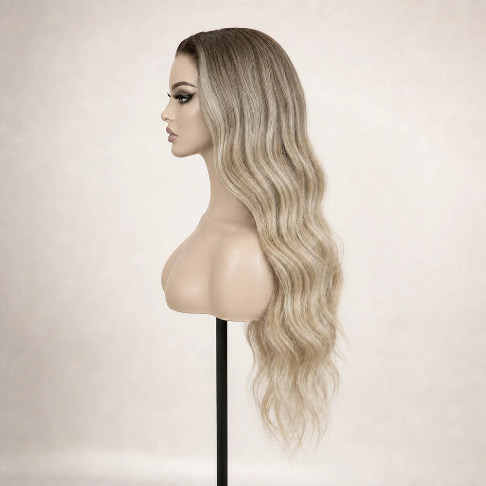 Front view of the Hugyoo Dark Root Ash Blonde Loose Wave glueless human hair wig on a mannequin.