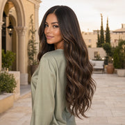 Woman wearing the Hugyoo Chestnut Balayage Loose Wave glueless human hair wig in a lifestyle setting.