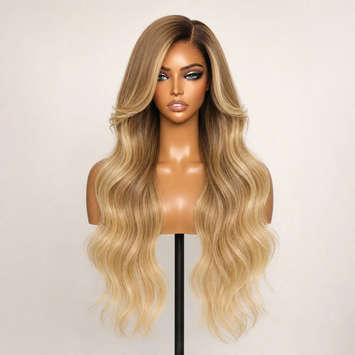 Front view of the Hugyoo Bronde Balayage Long Loose Wave glueless human hair wig on a mannequin.