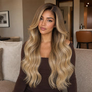 Woman wearing the Hugyoo Bronde Balayage Long Loose Wave glueless human hair wig in a lifestyle setting.