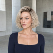 Woman wearing the Hugyoo Cool Blonde Textured Bob glueless human hair wig in a lifestyle setting.