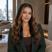 Woman wearing the Hugyoo Brown to Bronde Wavy Face Framing glueless human hair wig in a lifestyle setting.
