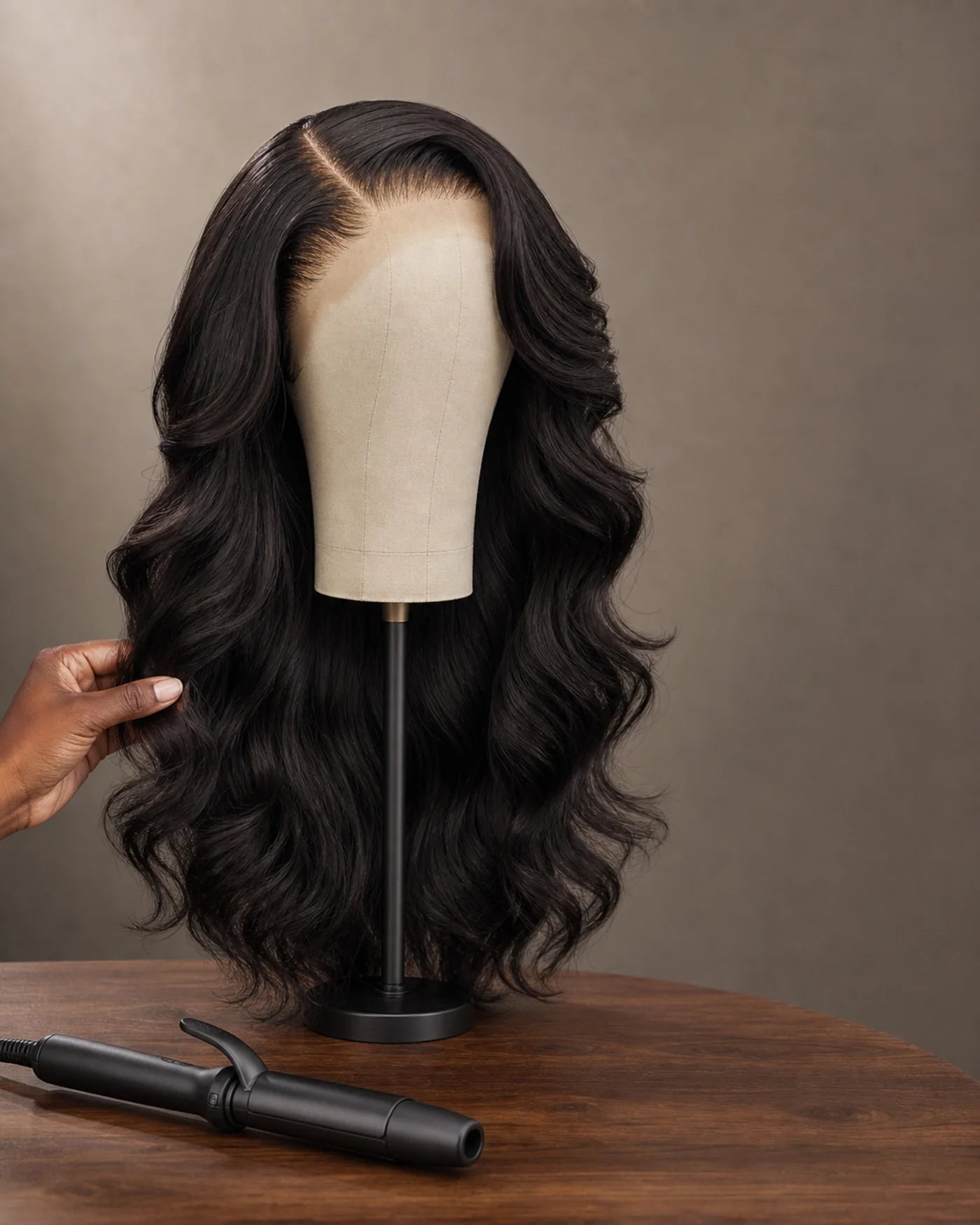 Long natural-black waves are refreshed into a defined style with a heat tool nearby.