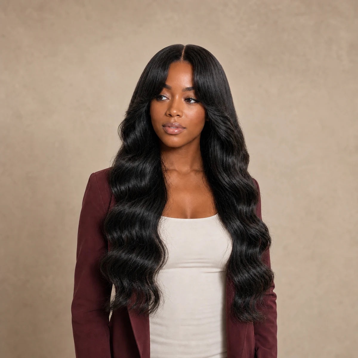 Black woman wearing long natural black waves with curtain bangs and face-framing layers, representing Hugyoo Bangs, Layers & Face-Framing wigs.