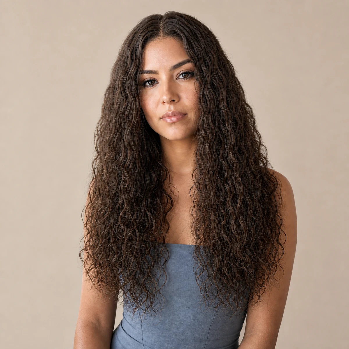 Woman wearing long brunette natural-texture curls, representing Hugyoo Curly wigs.