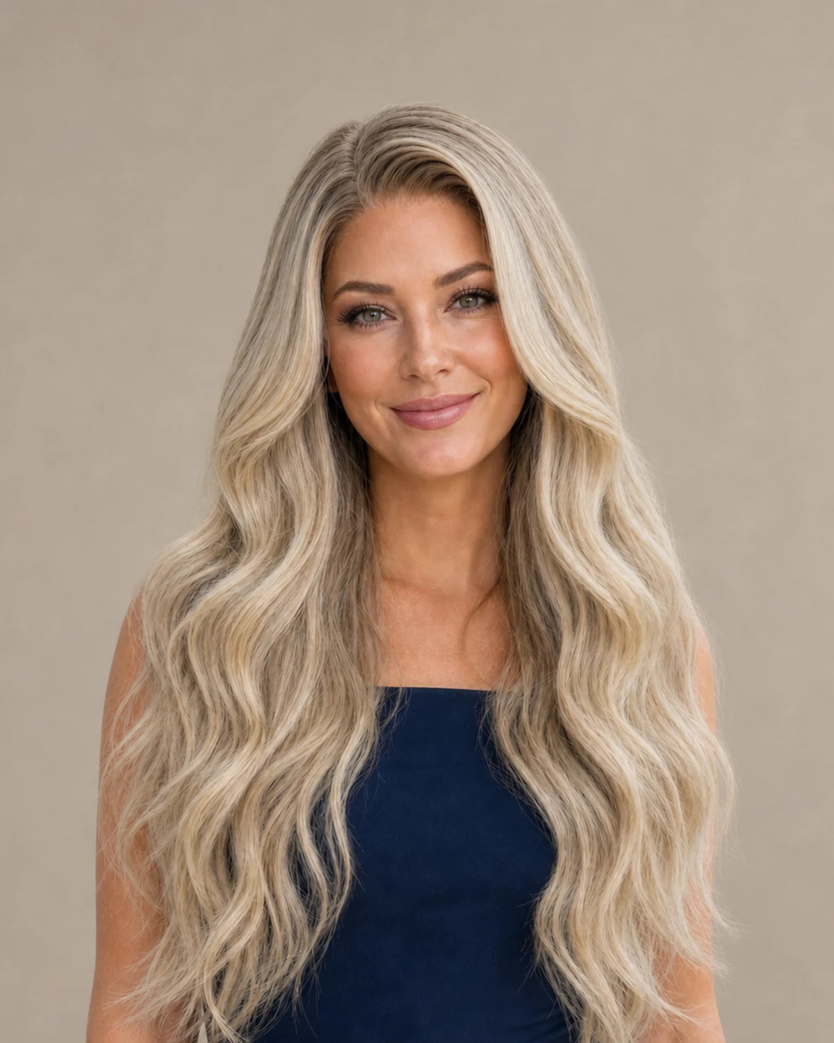 Woman wearing long dimensional blonde waves, representing Hugyoo Blonde wigs.